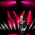 Young singer with colorful lights on concert